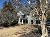 Charming home with a well-maintained lawn and mature trees adding character to the property at 405 Sycamore Trl, Woodstock, GA 30189