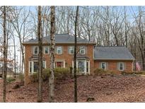 Brick two-story home features bay windows, shutters, and an American flag at 3542 Jefferson Township Pkwy, Marietta, GA 30066