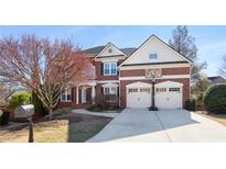 Charming two-story red brick home boasts a well-manicured lawn and a two-car garage with basketball hoop at 4095 Oberon Se Ct, Smyrna, GA 30080