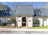Charming two-story condo with a brick facade, well-maintained landscaping, and inviting entryway at 93 Verlaine Nw Pl, Atlanta, GA 30327
