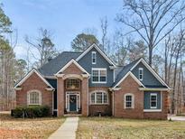 Traditional-style home featuring a brick facade, gray siding, and a welcoming front porch at 355 Parker Rd, Covington, GA 30014