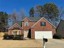 Charming two-story brick home featuring an attached two-car garage and well-maintained landscaping at 3004 Westray Nw Ct, Marietta, GA 30064