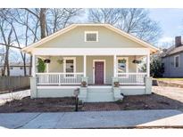 Charming craftsman home with a welcoming front porch, landscaped yard and painted in a pleasing color scheme at 1816 Williams Ave, East Point, GA 30344