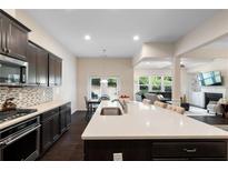 Modern kitchen boasts a large island, stainless steel appliances, and open floor plan to the living area at 2289 Emerald Sky Dr, Smyrna, GA 30080