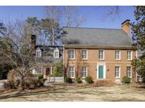 Beautiful brick home with a well-manicured lawn and a charming green front door at 270 Grapevine Run, Sandy Springs, GA 30350