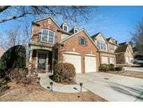 Beautiful brick townhome with two-car garage and manicured landscaping at 5751 Evadale Trce, Mableton, GA 30126