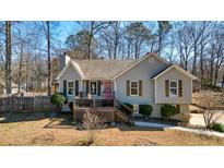 Charming home with a pink front door, wood shutters, and a cozy front porch at 1251 Oakdale Rd, Canton, GA 30114
