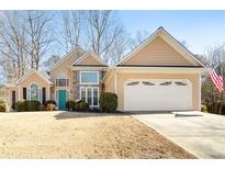 Charming traditional home with a manicured lawn, stone accents, and a two-car garage at 6272 Cheatham Lake Nw Dr, Acworth, GA 30101