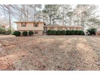 A charming brick home with manicured landscaping and a well-maintained front yard at 123 Creek Cir, Stockbridge, GA 30281