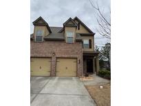 Charming two-story townhome with a brick facade and two-car garage at 1366 Image Xing, Lawrenceville, GA 30045