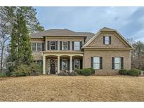 Traditional two-story brick home with a manicured lawn and symmetrical design at 2998 Octavia Cir, Marietta, GA 30062