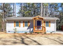 Charming single-story home with a cozy front porch and wood-trimmed windows at 3687 Venus Nw Pl, Atlanta, GA 30331