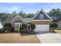 Charming brick and siding home with well-manicured front yard and two-car garage, perfect for suburban living at 339 Southgate Dr, Locust Grove, GA 30248