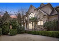 Stunning brick and stone home with manicured landscaping and a circular driveway for an elegant curb appeal at 3871 Trickum Road Ne, Marietta, GA 30066