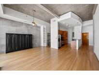 Spacious living room with hardwood floors, concrete walls, and modern ceiling fan at 943 Peachtree Ne St # 2009, Atlanta, GA 30309