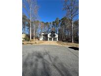 Charming two-story home with a two-car garage surrounded by mature trees and a well-manicured lawn at 2520 Deerfield Nw Dr, Kennesaw, GA 30144