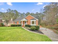 Charming brick home with well-maintained landscaping and a lush green lawn at 2274 Glenridge Dr, Marietta, GA 30062