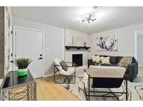 Inviting living room features a cozy fireplace, modern decor, and lots of natural light at 839 Kennesaw Dr, Forest Park, GA 30297