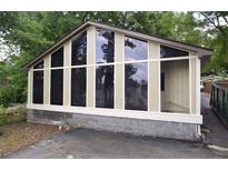 Bright sunroom with large windows and view of the green surroundings at 4011 Florida Ave, Atlanta, GA 30360