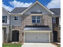 Charming townhome with a brick facade, gray accents, and a two-car garage, enhancing its curb appeal at 684 Sundial Ln, Mableton, GA 30126