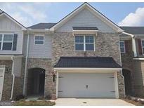 Charming two-story townhome with a brick and gray facade and a two-car garage at 684 Sundial Ln, Mableton, GA 30126