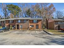 Brick townhome features a traditional design with a front parking lot at 4526 Golf Vista Cir, Decatur, GA 30035