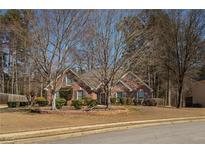 Charming brick home with mature landscaping, situated on a well-manicured lot at 506 Morning Glory Ct, Sugar Hill, GA 30518