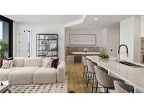Bright living room featuring modern furniture, an open layout, and beautiful hardwood floors, creating an inviting atmosphere at 2425 Peachtree Ne Rd # 903, Atlanta, GA 30305