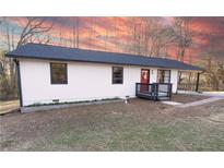 Charming single story home with white siding, black trim, a red door, and well-manicured lawn at 4776 Ballew Dr, Powder Springs, GA 30127