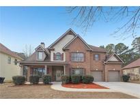 Stunning brick home with well-manicured landscaping and a two-car garage at 2143 Great Shoals Cir, Lawrenceville, GA 30045