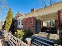 Charming brick home featuring a covered front porch, perfect for outdoor relaxation at 38 Bates Se Ave, Atlanta, GA 30317