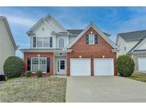 Charming two-story home with brick accents, a two-car garage, and a well-manicured front lawn at 1255 Leisure Lake Drive, Lawrenceville, GA 30044