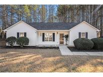 Charming single-story home featuring a well-maintained lawn, classic black shutters, and a welcoming front entrance at 192 Conifer Ln, Rockmart, GA 30153