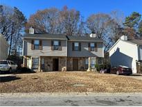 Traditional two-story home featuring stone accents, neutral siding, and a well-maintained front lawn at 3636 Hopkins Ct, Powder Springs, GA 30127