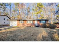 Charming brick home with a well-maintained front yard and attached garage at 473 Oakside Sw Dr, Atlanta, GA 30331