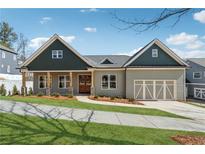 Charming single-Gathering home featuring a craftsman style and beautifully manicured front yard at 9089 Hanover St, Lithia Springs, GA 30122