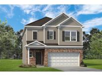 Charming two-story home features a brick facade, gray siding, and a two-car garage at 1265 Elowen Dr, Austell, GA 30168