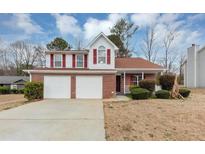 Charming two-story brick home with a two-car garage and red shutters at 324 Cheri Pl, Jonesboro, GA 30238