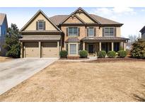 Charming two-story home with a well-manicured lawn and a two car garage at 4445 Trilogy Park Trl, Hoschton, GA 30548