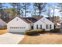 Charming single-story home featuring a well-maintained lawn and attached garage at 4519 Legend Hollow Ln, Powder Springs, GA 30127