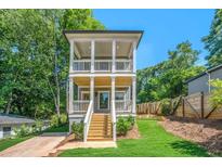 Charming two-story home featuring double porches, landscaped yard, and a modern exterior design at 57 Moury Se Ave, Atlanta, GA 30315