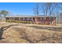 Charming brick home featuring a well-maintained front yard and a classic, inviting facade at 346 Mays Rd, Stockbridge, GA 30281