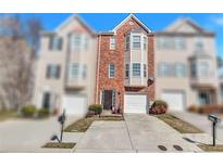 Charming brick townhome with attached garage and well-maintained landscaping at 2565 Rocky Ct, South Fulton, GA 30349