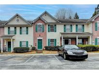 Attractive townhome exterior features a brick facade, neutral siding, and green shutters, creating a welcoming curb appeal at 3154 Panthers Trce, Decatur, GA 30034