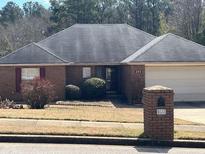 Charming brick home featuring a well-maintained front yard and attached garage at 355 Tait Rd, Stockbridge, GA 30281