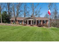 Charming brick home with a manicured lawn and welcoming front porch perfect for relaxing outdoors at 3250 N Embry Cir, Atlanta, GA 30341