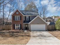Charming two-story home featuring a brick facade, attached garage, and well-maintained landscaping at 1098 Berkley Se Dr, Smyrna, GA 30082