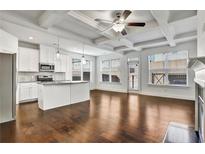 Bright living room featuring hardwood floors, modern ceiling fan, and an island kitchen at 2240 Mulsanne Dr, Lithonia, GA 30058