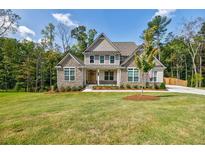 Beautiful two-story home with stone and shake siding and a lush green lawn at 783 Phil Haven Ln, Kennesaw, GA 30152