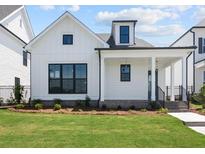 Charming, craftsman style home with white wood facade, black trim, and an inviting front porch at 528 Pearl St, Cumming, GA 30519